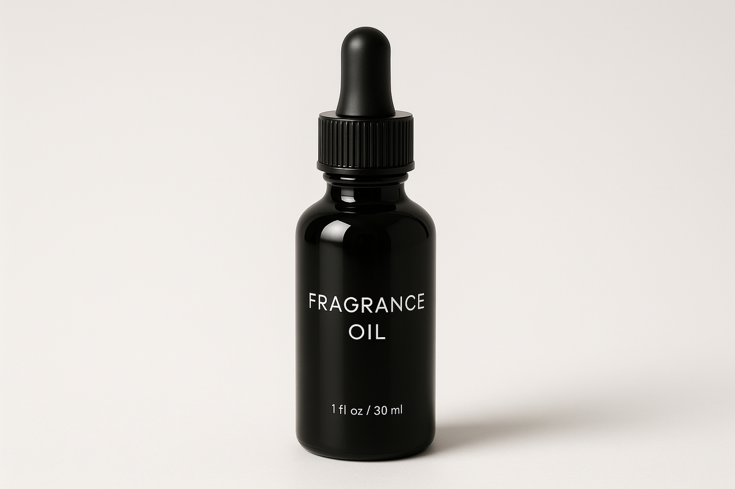 1oz black glass droper fragrance oil writing on it